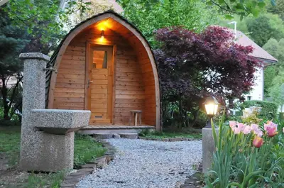 a small wooden dog house with a light on it at Grajski oddih in Cerklje na Gorenjskem