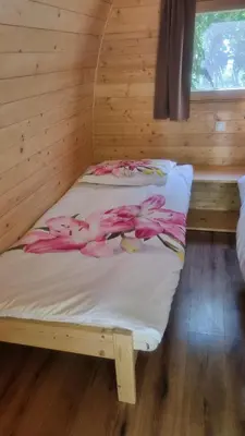 two beds in a cabin with pink flamingos on them at Grajski oddih in Cerklje na Gorenjskem