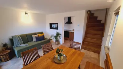 a living room with a table and a couch at Zidanica Muhič in Dolenjske Toplice