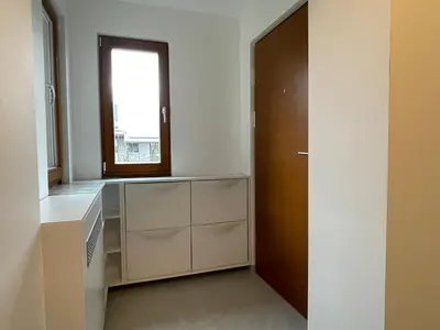 a kitchen with white cabinets and a window at ANMARI Apartment & Rooms in Radovljica