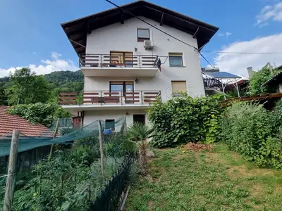 a house with a balcony on the side of it at Apartma DOMA in Tolmin