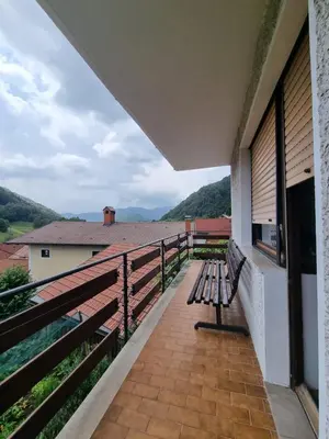 a bench sitting on the balcony of a house at Apartma DOMA in Tolmin