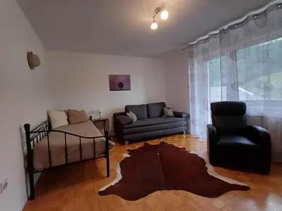 a living room with a couch and a chair at Apartma DOMA in Tolmin