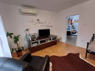 a living room with a tv and a couch at Apartma DOMA in Tolmin
