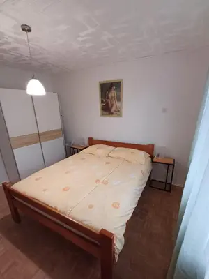 a small bedroom with a bed in a room at Apartma DOMA in Tolmin