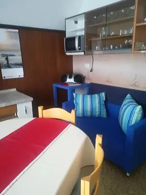 a bedroom with a bed and a blue couch at Apartments & Rooms Stare in Bohinj