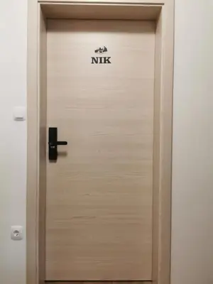 a wooden door with the word nk on it at Apartments Marica in Kranjska Gora