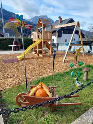 a playground with a pumpkin in a wheelbarrow at Apartments Marica in Kranjska Gora