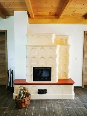 a living room with a fireplace with a tv at Holiday Home - Goričko Park in Kobilje