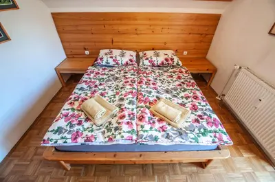 a bed with two pillows on it in a room at Veduta Apartment Bohinj Lake in Bohinj