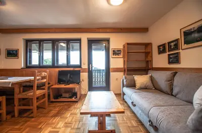 a living room with a couch and a table at Veduta Apartment Bohinj Lake in Bohinj