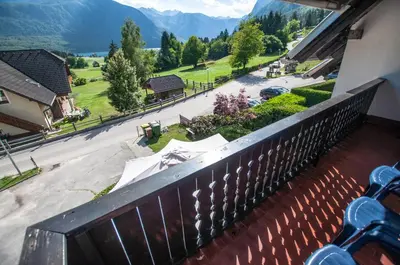 a balcony with a view of a street and mountains at Veduta Apartment Bohinj Lake in Bohinj