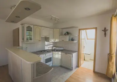 a kitchen with white cabinets and a counter top at Apartment Amak with free onsite parking in Bovec