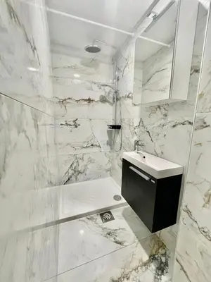 a white bathroom with a sink and a shower at Čebelnk: sanjska hišica 4 km od Bleda in Lesce