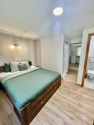 a bedroom with a large bed and a bathroom at Čebelnk: sanjska hišica 4 km od Bleda in Lesce
