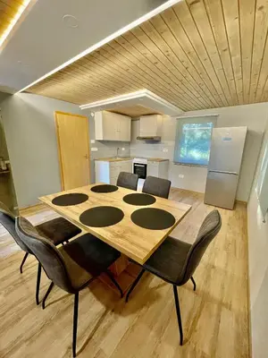 a dining room table and chairs in a room at Čebelnk: sanjska hišica 4 km od Bleda in Lesce