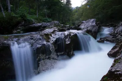 a waterfall in the middle of a river at Apartments Vila Jelka in Bohinj
