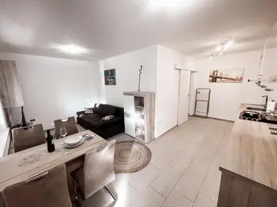 a living room with a couch and a table at RIAD Apartments in Zgornje Škofije