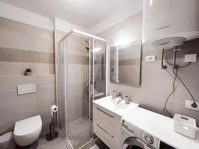 a bathroom with a toilet and a sink and a shower at RIAD Apartments in Zgornje Škofije