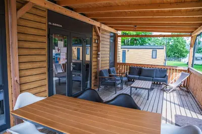 a patio with a table and chairs on a deck at Camp Velenje in Velenje
