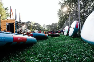 a row of surfboards lined up on the grass at Camp Velenje in Velenje