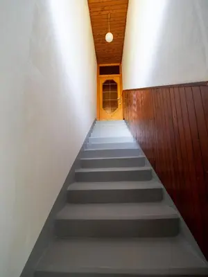 a stairway leading up to a door in a building at Kiara Apartments & Rooms in Jesenice