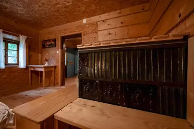 a wooden room with a wooden bench in a house at Domačija Gačnik in Idrija