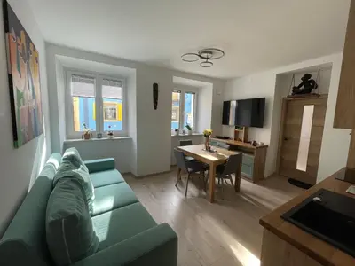 a living room with a blue couch and a table at RITUAL in Ajdovščina