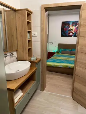a bathroom with a sink and a bed at RITUAL in Ajdovščina