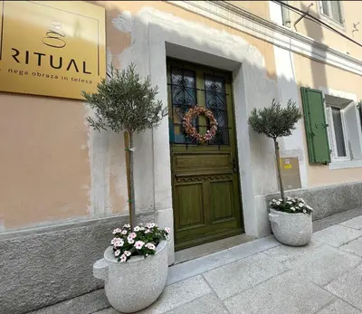 two potted plants sitting in front of a door at RITUAL in Ajdovščina