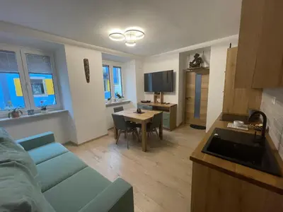 a living room with a blue couch and a table at RITUAL in Ajdovščina