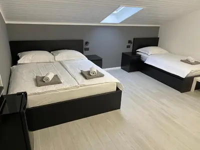 a bedroom with two beds with hats on them at Room Aria in Kobarid