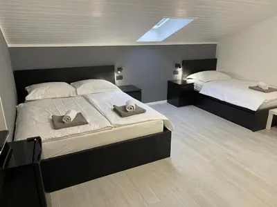a bedroom with two beds with hats on them at Room Aria in Kobarid