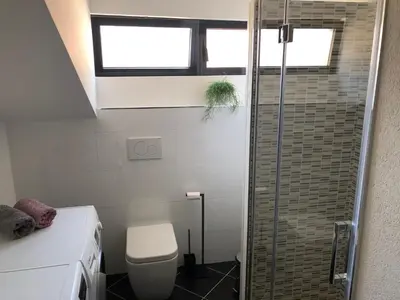 a bathroom with a toilet and a glass shower at Room Aria in Kobarid