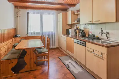 a kitchen with a table and a sink in it at Holiday House Radovna Bled in Zgornje Gorje