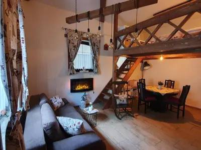 a living room with a couch and a table at Studio Srce in Kranjska Gora