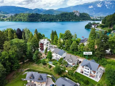 an aerial view of a house with a lake at Vila Petra - Family apartment for 4 at Lake Bled in Bled