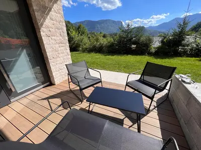 two chairs and a table on a deck at Vila Petra - Family apartment for 4 at Lake Bled in Bled