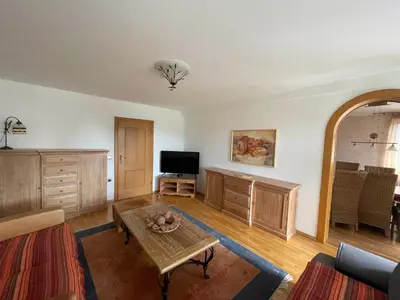 a living room with a table and a tv at Apartmaji Iva in Bled