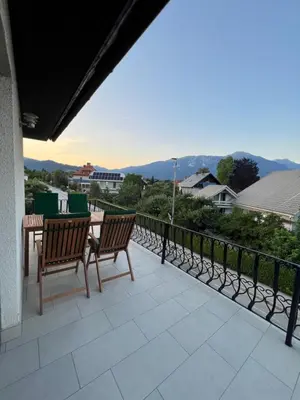 a patio with two chairs and a table on a balcony at Apartmaji Iva in Bled