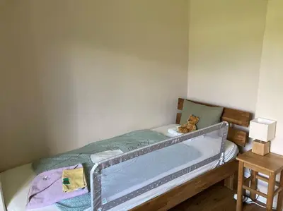 a small bedroom with a bed with a tub at Vila Mir - Apartment in Begunje na Gorenjskem