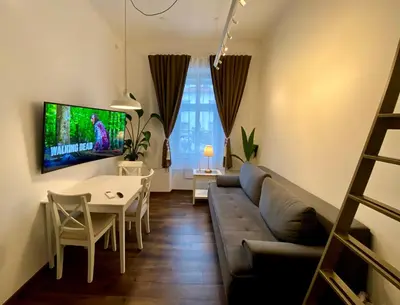 a living room with a couch and a table at Ars Longa apartments in Ljubljana