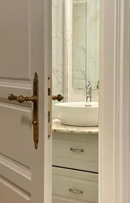 a bathroom door with a sink and a mirror at Ars Longa apartments in Ljubljana