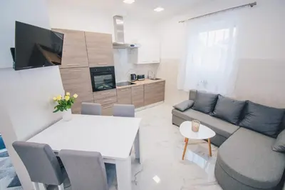 a living room with a couch and a table at L Apartment in Maribor