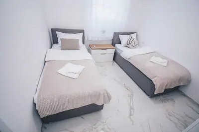 two beds sitting next to each other in a room at L Apartment in Maribor