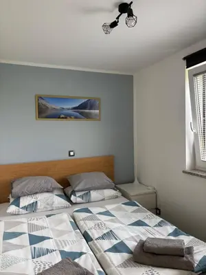 a bedroom with two beds and a ceiling at Apartmaji ob Savi in Bohinj