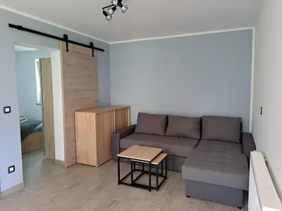 a living room with a couch and a table at Apartmaji ob Savi in Bohinj
