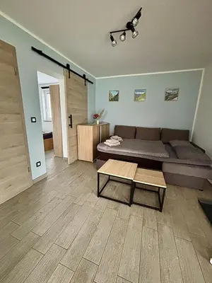 a living room with a couch and a table at Apartmaji ob Savi in Bohinj