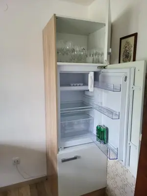 an empty refrigerator with its door open at Sava river house - apartments in Bled