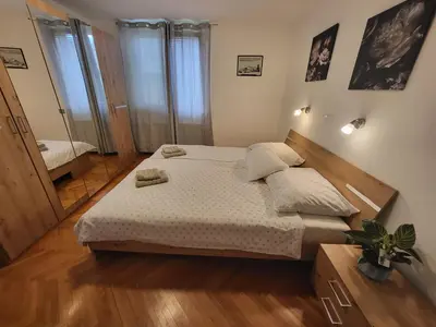 a bedroom with a bed and a mirror at Sava river house - apartments in Bled